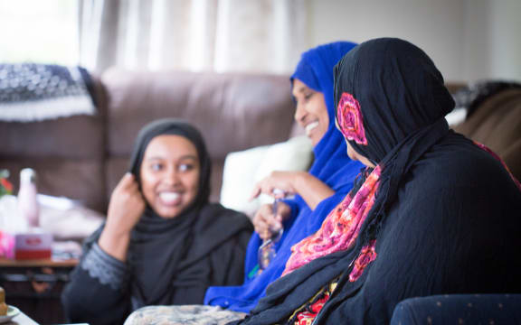 Asha, Muhubo and her mother Amina in Muhubo's new Housing New Zealand home that is large enough for the six adults in her family. Since moving out of their overcrowded house, Muhubo is happier and her health is improving.