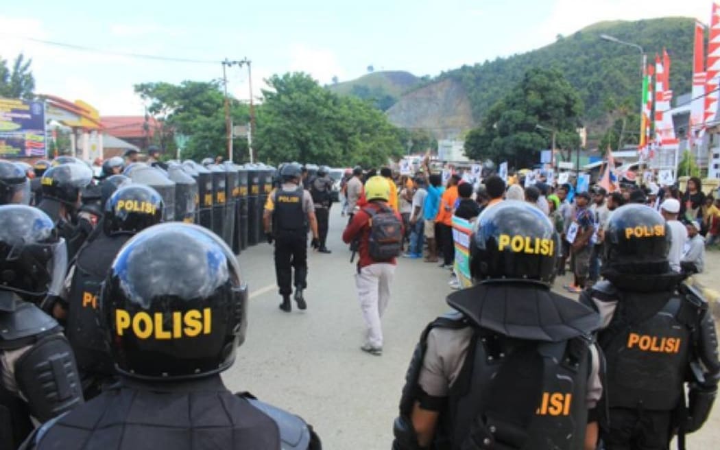 Police blockade the protest in Jayapura.