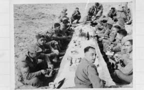 Members of the 28 Maori Batallian eating Christmas Dinner in the desert, Nofilia (Libya), on Christmas Day of 1942.