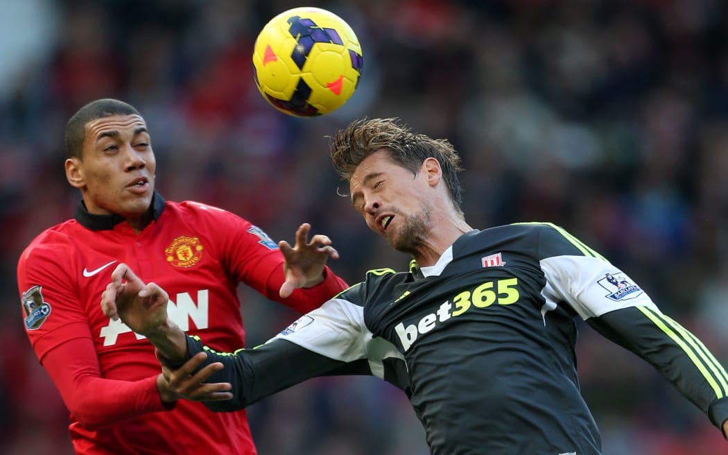 Chris Smalling of Man Utd battles with Peter Crouch of Stoke.