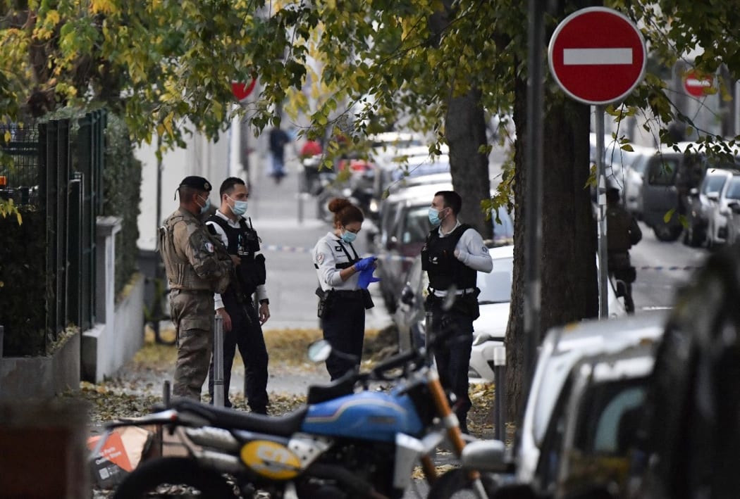 Security and emergency personnel are on October 31, 2020 in Lyon at the scene where an attacker armed with a sawn-off shotgun wounded an Orthodox priest in a shooting before fleeing, said a police source.