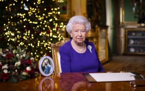 A picture released on 24 December 2020 shows Britain's Queen Elizabeth II posing for a photograph after she recorded her annual Christmas Day message, in Windsor Castle.
