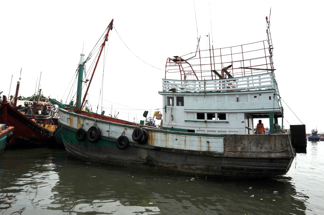 A wooden fishing boat used to transport nearly 600 mostly Rohingya migrants rests anchored at Lhokseumawe in Indonesia on 14 May.