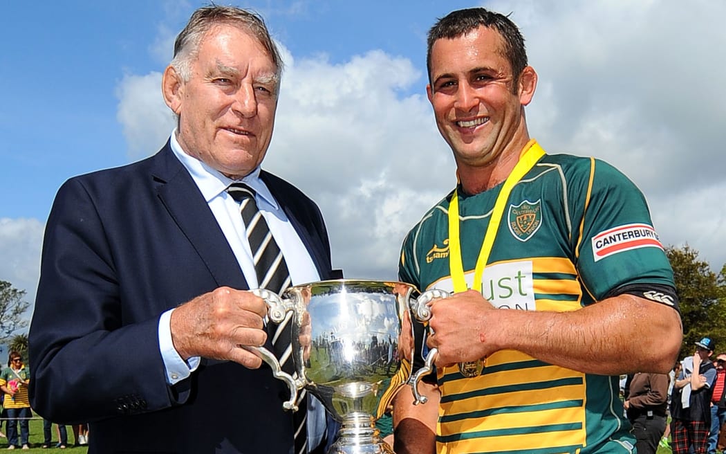 Sir Colin Meads presents his trophy to Mid-Canterbury captain Jon Dampney