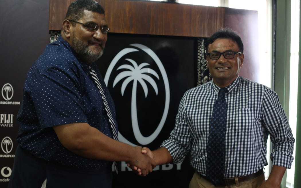 Fiji Rugby Union CEO John O'Connor shakes hands with new FRU Chairman Conway Beg.