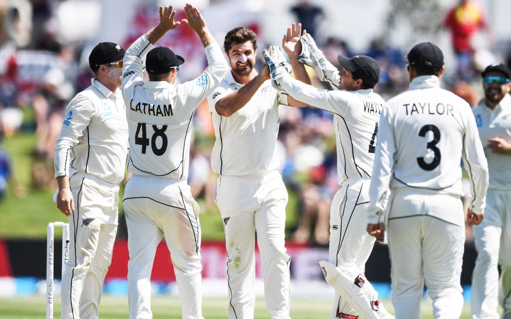 Colin de Grandhomme celebrates with team mates the wicket of Rory Burns during the first Test match at Bay Oval in Mt Maunganui, 2019.
