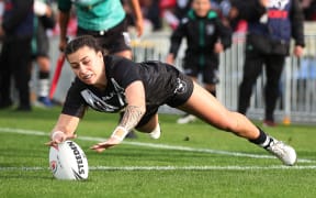 Madison Bartlett of New Zealand runs in a try during the women’s rugby league test match between New Zealand and Tonga at Mt Smart Stadium in Auckland.