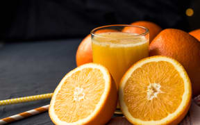 Fresh orange juice and fresh fruit oranges on a black background