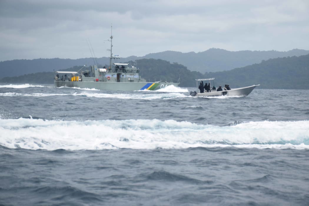 A RSIPF patrol boat and fast craft patrolling the Solomon Islands side of the common border with PNG with Bougainville in the background.