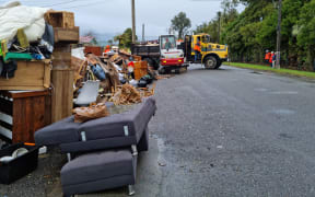 The crews started work this morning collecting carpet and household items that were put out on the kerb in Menzies St.