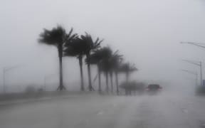 Commuters make their way through heavy rain in Jacksonville, Florida, ahead of hurricane Matthew.