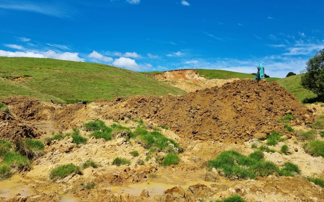 A digger works to clear a slip in Northland.