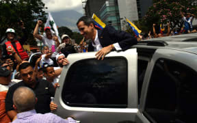 Venezuelan opposition leader and self-proclaimed acting president Juan Guaido greets supporters upon his arrival in Caracas on March 4, 2019.
