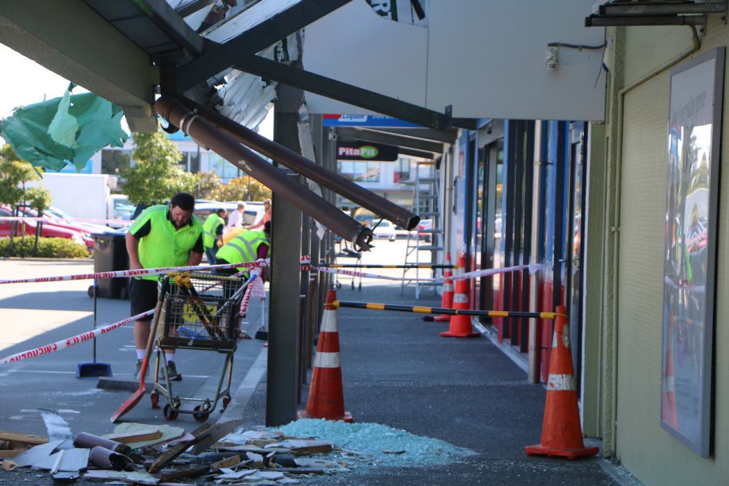 Crews cleaning up the area where a truck crashed into a shop on Barrington Street in Christchurch.