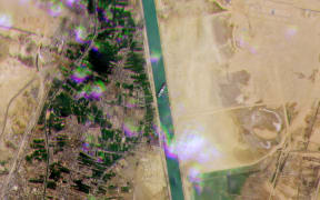 A satellite image by Planet Labs Inc shows the Taiwain-owned ship 'Ever Given', operated by the shipping company Evergreen, lodged sideway sacross Egypt's Suez Canal.