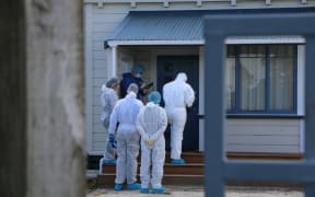 Investigators at the Taranaki home that is the focus of a double homicide inquiry.