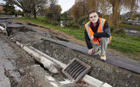 Misko Cubrinovski, from the University of Canterbury's School of Engineering, studies liquefaction and lateral spreading on Oxford Terrace, after the 2011 Christchurch earthquake.