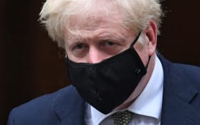 Britain's Prime Minister Boris Johnson wearing a face mask  leaves 10 Downing Street ion October 12, 2020 headed for the House of Commons, where he is set to announce a new Covid-19 alert system.