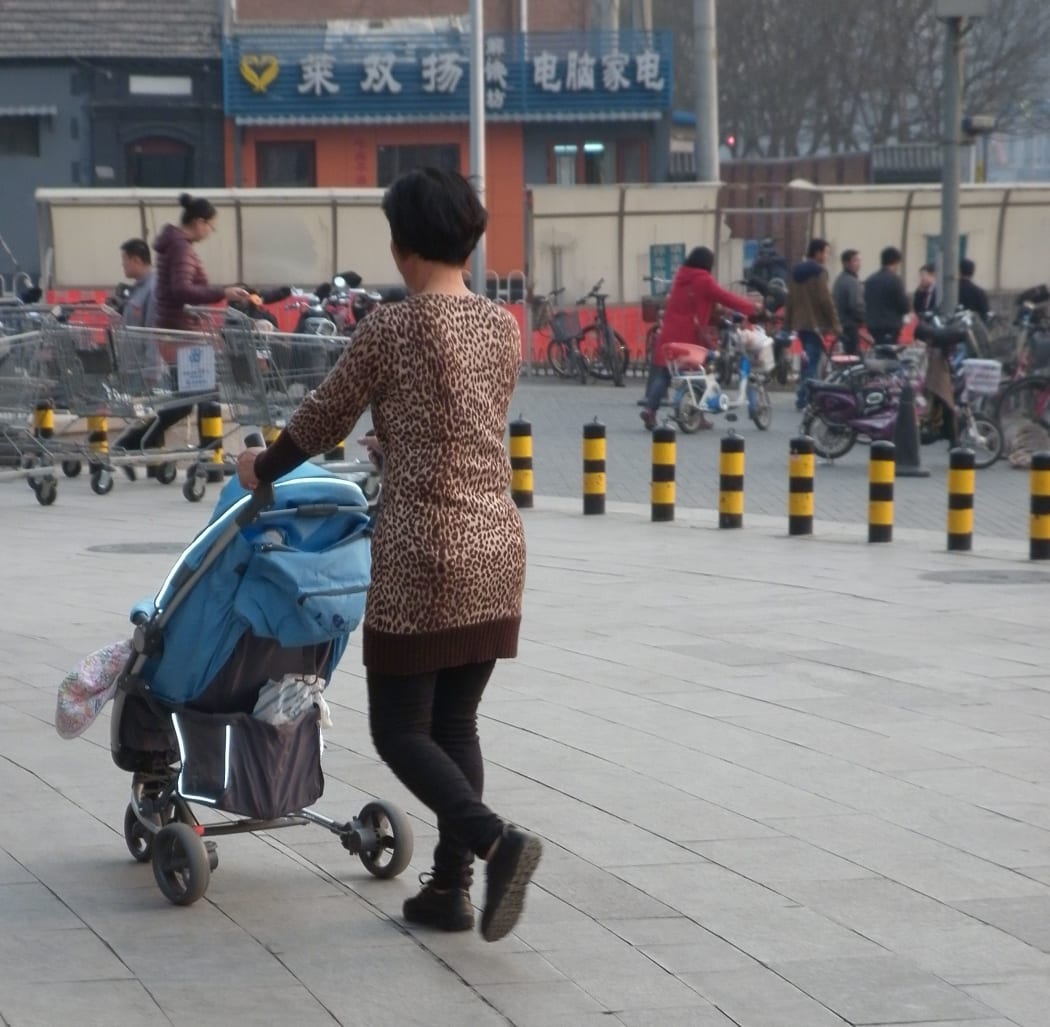 Mother and child on street in Beijing a city where some parents are unclear about the safety of New Zealand milk products.