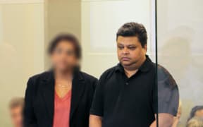 Rohit Deepak Singh standing alongside an interpreter at the High Court in Auckland.