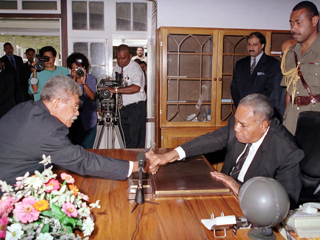 Laisenia Qarase (L) shakes hands with president Josefa Iloilo after a swearing in ceremony following the 2001 election.