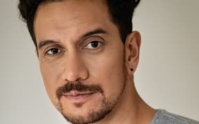 James Nokise, a Samoan, Welsh and New Zealand comedian, looks directly into the camera. He is smiling slightly.
