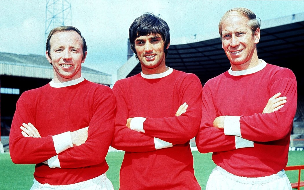 Nobby Stiles, George Best and Bobby Charlton of Manchester United pose for the cameras at Old Trafford in Manchester, England, 1968.