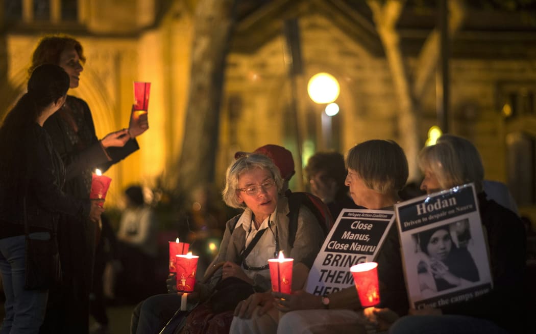Participants hold a candle light vigil in May 2016 for asylum seekers who set themselves on fire on Nauru.