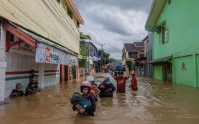 Residents evacuating their homes in Makassar as heavy rain and strong winds pounded the southern part of Sulawesi island