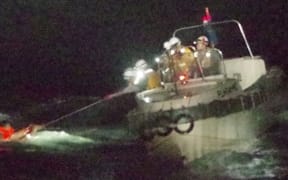 One person has been rescued after a cargo ship capsized in a typhoon off Japan's coast.