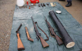 Guns, cash and drugs were seized in a Buller police raid.
