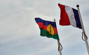 French, right, and Kanak flags.