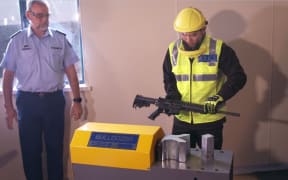Police demonstrate how guns will be destroyed under the buy-back scheme.