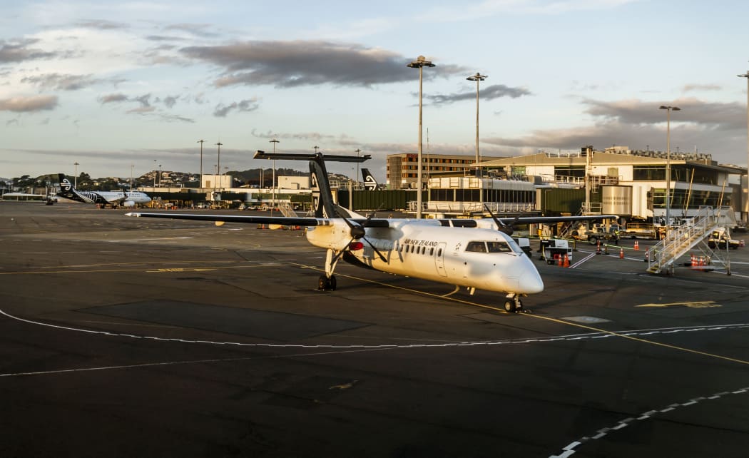 Wellington, New Zealand - January 04, 2019: Aeroplane at the Wellington terminal gate ready for takeoff during sunset on Wellington, New Zealand.