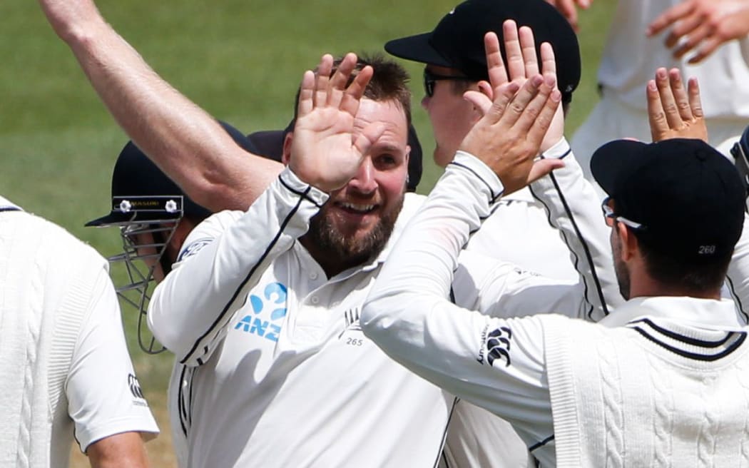 Spinner Mark Craig celebrates taking a wicket with his New Zealand team-mates.