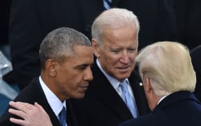 Barack Obama and Joe Biden speak with Donald Trump at his inauguration in January 2017.