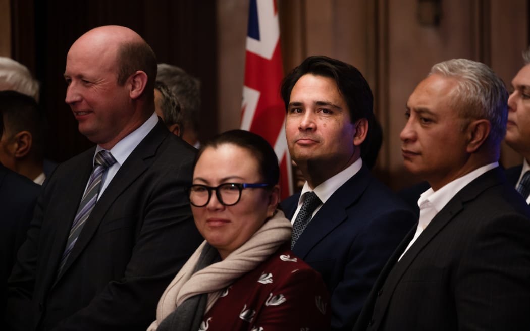 Former National Party leader Simon Bridges stands with other members of the party after Judith Collins is announced as the new leader, taking over from Todd Muller.