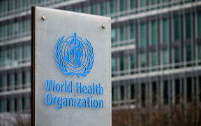 This photograph taken on December 2, 2021, shows a sign of the the World Health Organization (WHO) next to theirs headquarters, in Geneva. - The WHO has issued stern warnings on the dangers of vaccination apathy and the European Union put mandatory jabs on the table as the United States registered its first case of the fast-spreading Omicron strain of the coronavirus. (Photo by Fabrice COFFRINI / AFP)