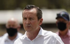 Western Australia state Premier Mark McGowan (C) speaks to media announcing that 72 homes have been destroyed by fires, in Perth on February 3, 2021. (Photo by Trevor Collens / AFP)