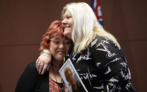 Relatives of mine victims Anna Osborne and Sonya Rockhouse embrace after the announcement of the re-entry plan.