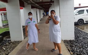 Two nurses in Samoa wearing masks during the measles epidemic.