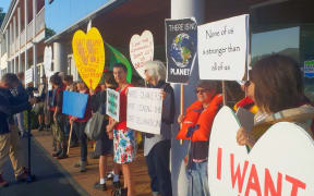 Protesters outside the Thames Coromandel District Council after the council voted against signing a nationwide climate change declaration.