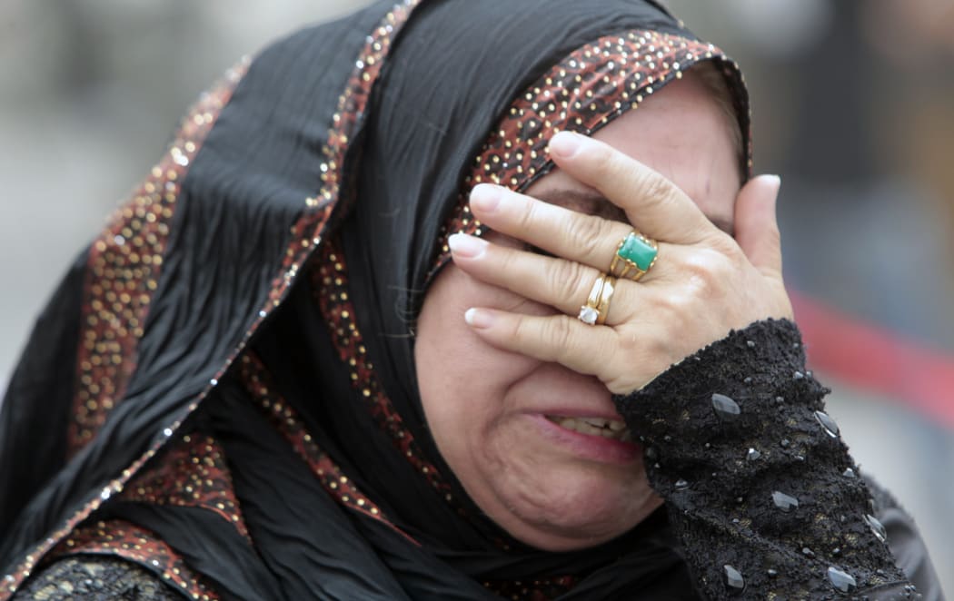 An Iraqi woman whose flat was destroyed in a massive bombing in Baghdad's Karrada neighbourhood reacts as she visits the aftermath of the attack.