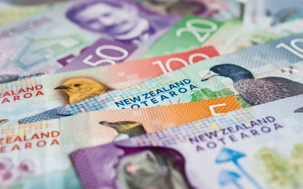 Pile of New Zealand currency laying flat on table