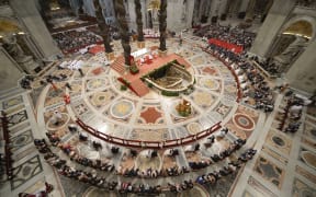 Brides and grooms during their wedding ceremony at St Peter's Basilica.