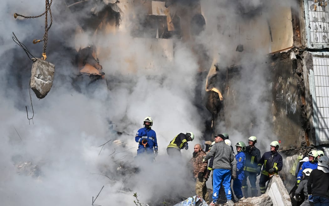 Rescuers search for survivors in the rubble of a damaged residential building in Uman, around 215km south of Kyiv, on April 28, 2023, after Russian missile strikes targeted several Ukrainian cities overnight.