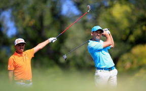 Rickie Fowler of the United States (left) watches the tee shot of Sergio Garcia of Spain during the BMW Championship.
