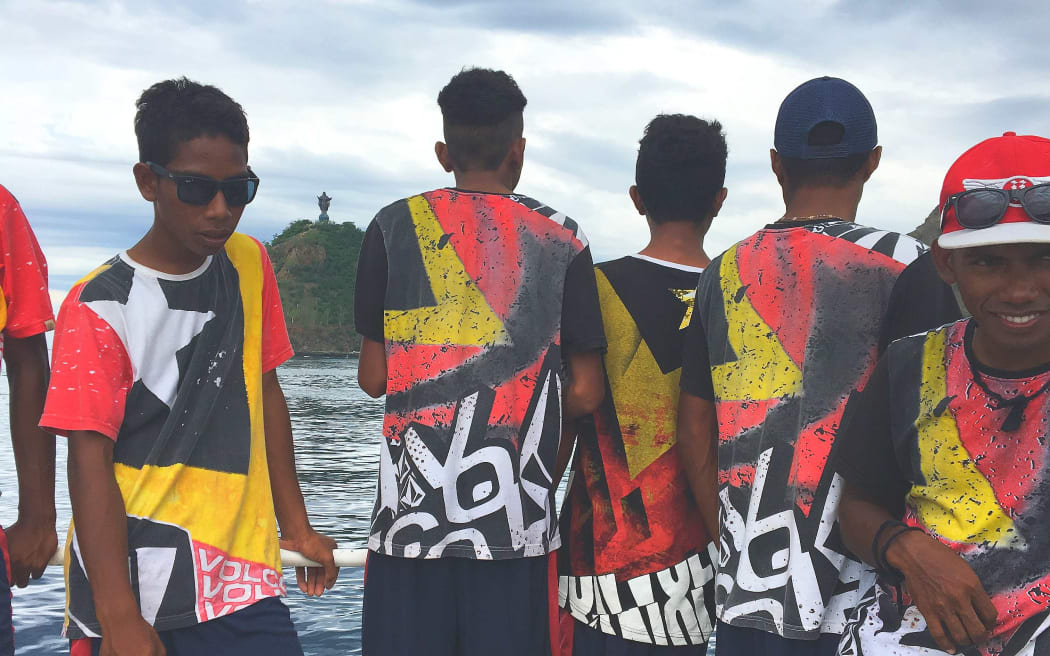 Boys wearing t-shirts with design based on the flag of Timor Leste
