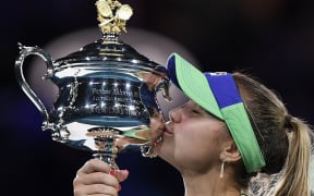 Sofia Kenin of the US kisses the Daphne Akhurst Memorial Cup after winning against Spain's Garbine Muguruza in their women's singles final match  Australian Open tennis tournament in Melbourne on February 1, 2020.