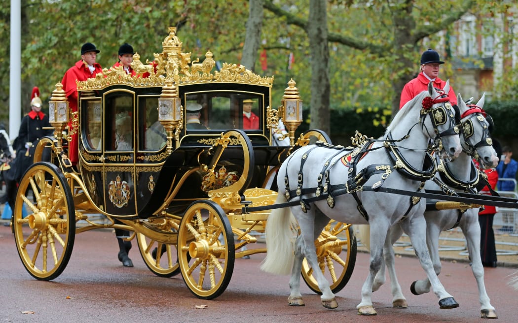 Britain's Queen Elizabeth II rides with Britain's Prince Charles, Prince of Wales and Britain's Camilla, Duchess of Cornwall in Diamond Jubilee State Coach as she leaves Buckingham Palace in London on October 14, 2019 heading to the Houses of Parliament for the State Opening of Parliament. - The State Opening of Parliament is where Queen Elizabeth II performs her ceremonial duty of informing parliament about the government's agenda for the coming year in a Queen's Speech. (Photo by ISABEL INFANTES / AFP)